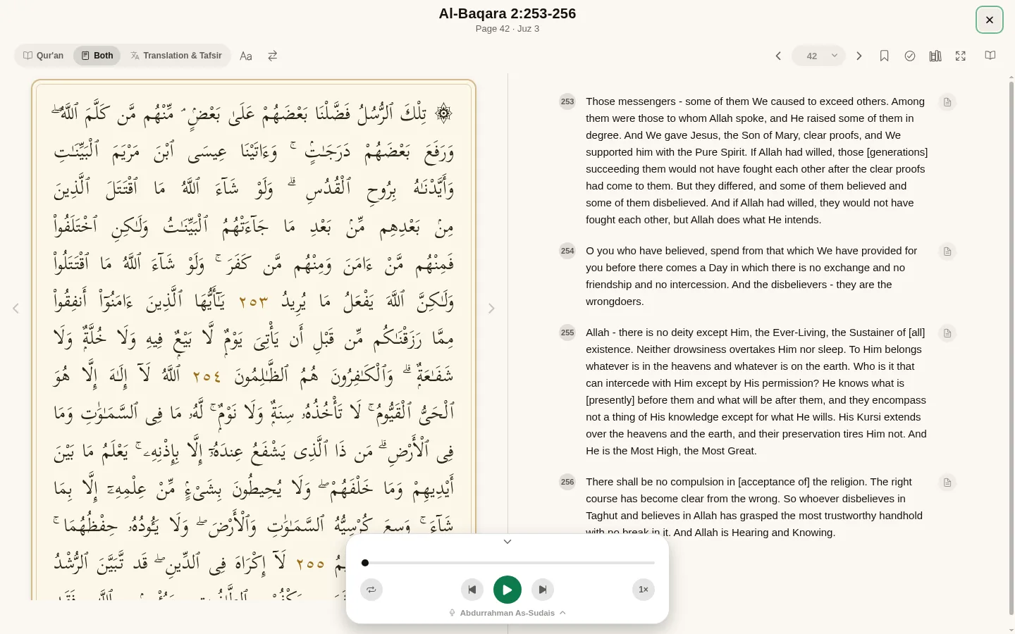 The mushaf on a desktop, the Arabic page on the left and numbered translations on the right.
